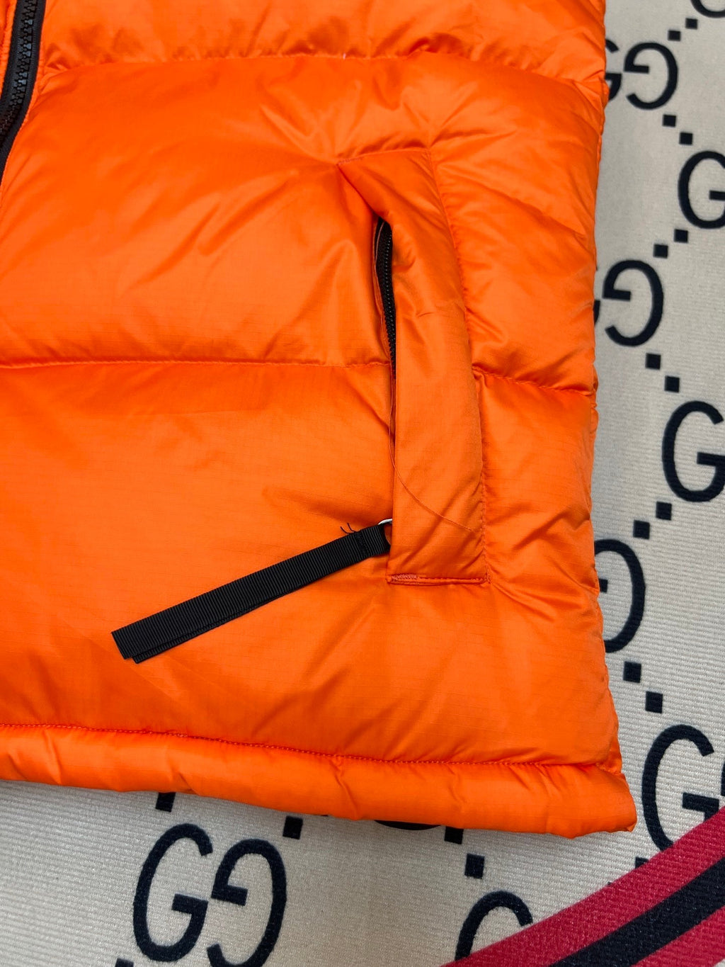 The North Face Puffer Vest in Orange and Black with Stand Collar